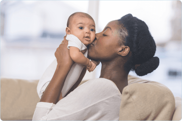 Lady kissing a baby