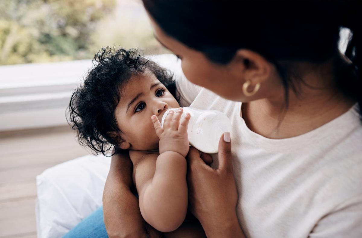 Mother feeding baby from bottle