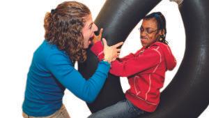 Girl on swing with therapist