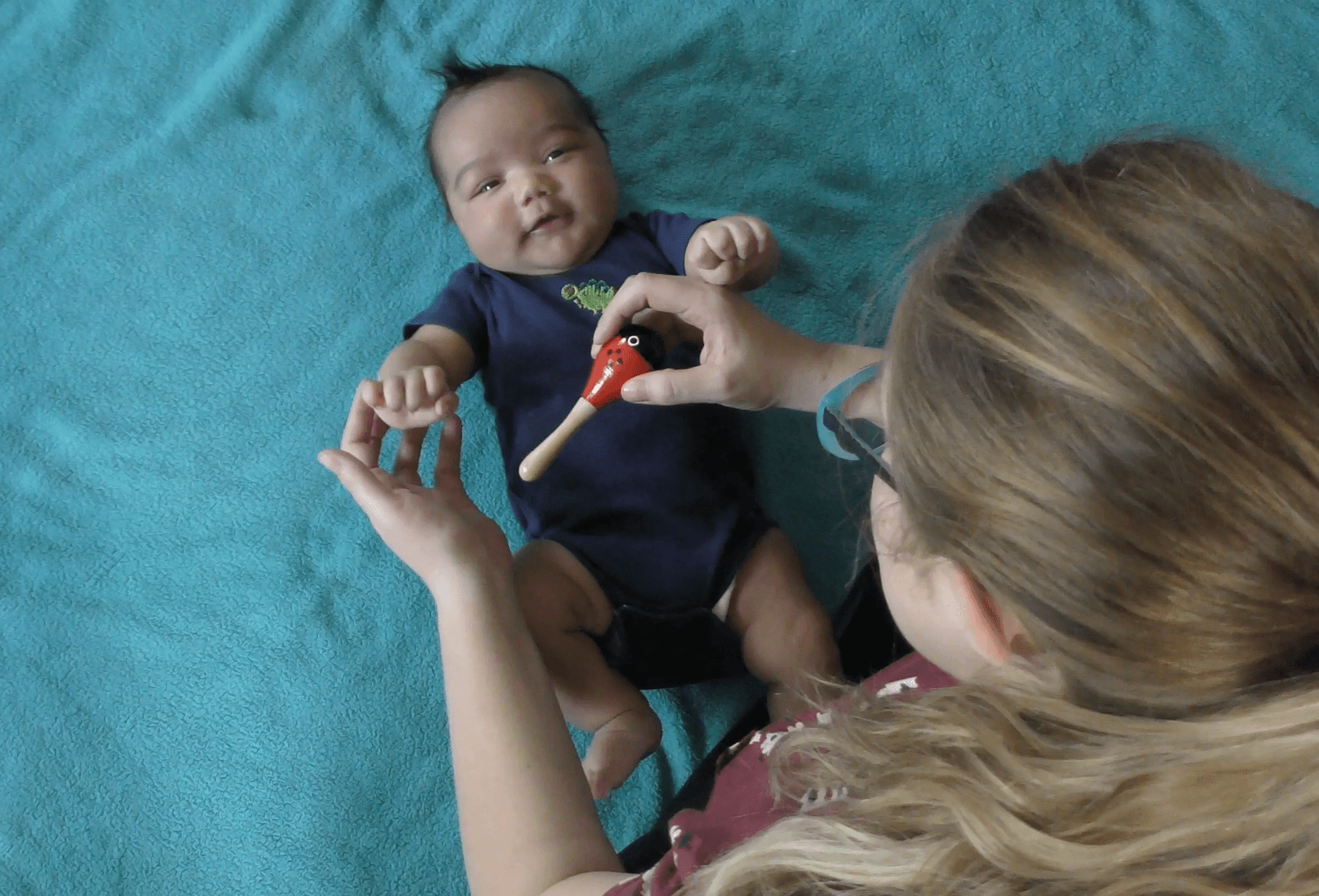 Playing with baby and rattle