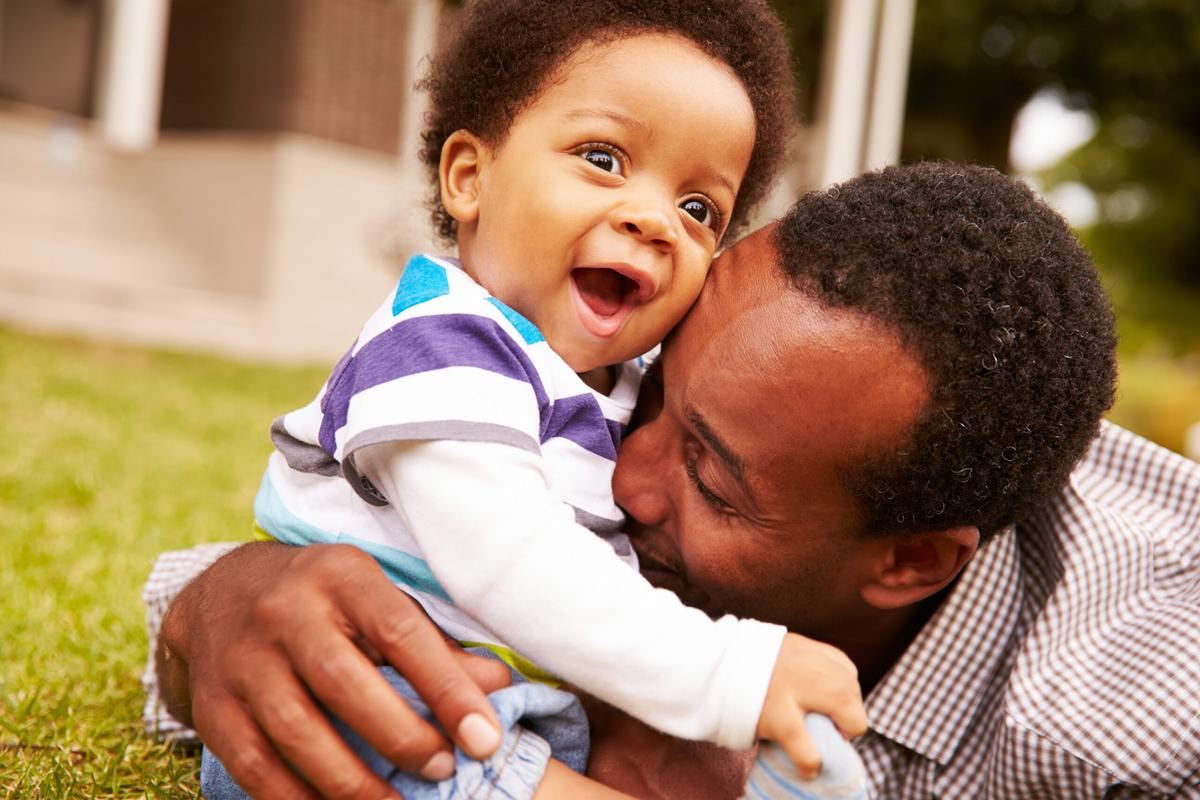Father and son bonding while playing in park