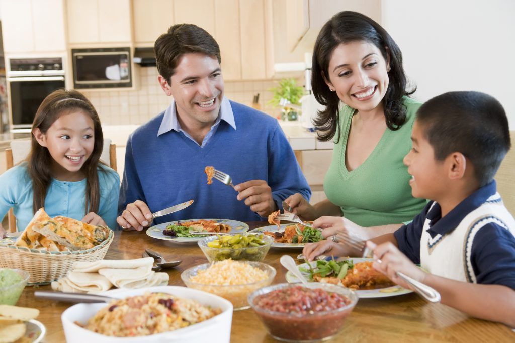 family of four having dinner together