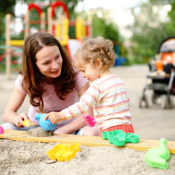 mom_and_daughter_playing_with_toys_in_sand