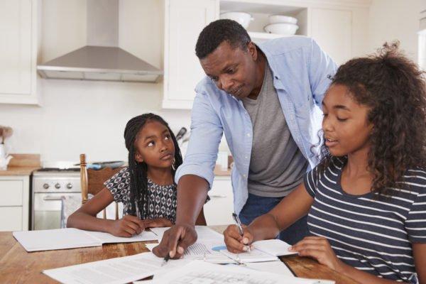 Father_Helping_Two_Daughters_With_Homework