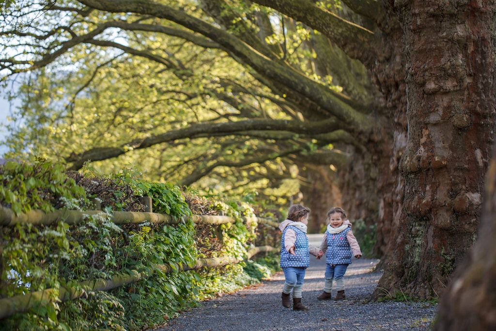 twin-girls-running-under-trees