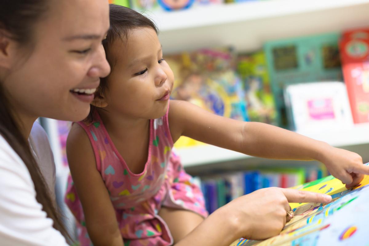 Mother and baby looking at picture hunt book together