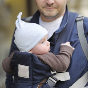 Father and his baby in a baby carrier