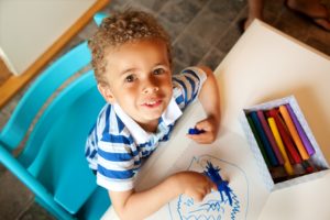 preschooler_playing_with_a_box_of_crayons