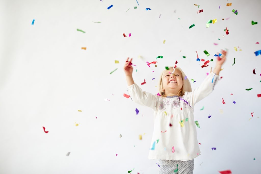 Girl Throwing Confetti In White Room Website 1024x682 