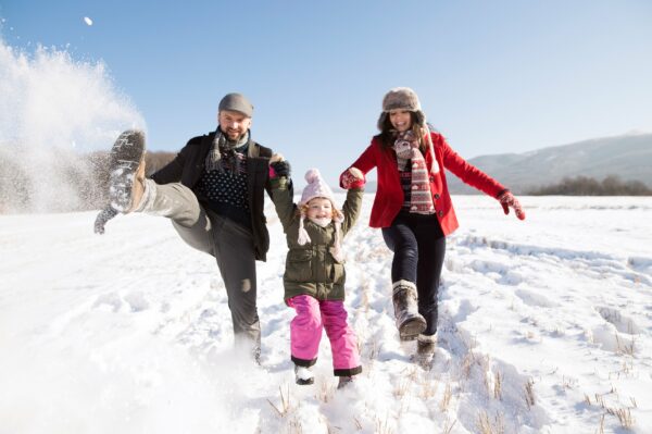 Family enjoying with their child in snow