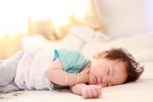 young child sleeping on side