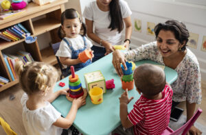 Nursery-children-playing-with-teacher-in-the-classroom