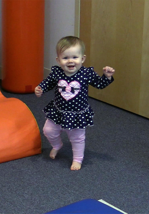 toddler_taking_first_steps_with_mom