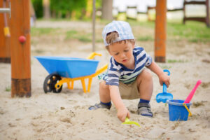 Young boy pretend playing in the sand