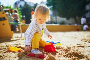 girl_in_sandpit_at_playground