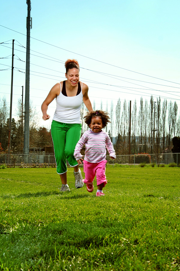 Mother-and-Daughter-Running-Through-Park