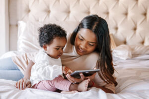 mother-with-toddler-baby-girl-watching-cartoons-on-a-tablet
