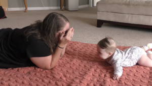 Mom doing Tummy Time with baby