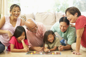 Extended family playing board games to teach children basic math skills